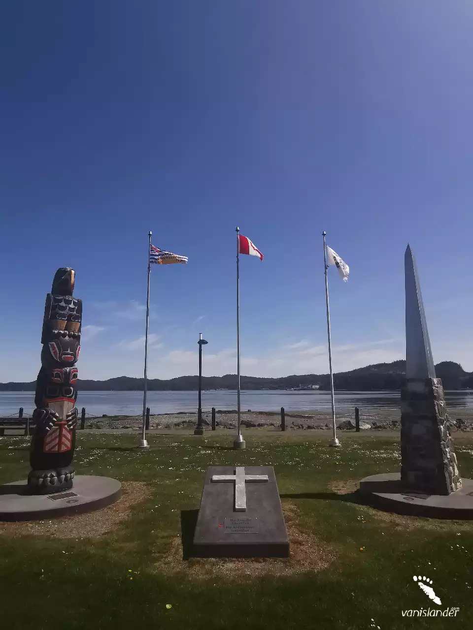 Totem, cenotaph and B.C. flag view in Port Hardy, Vancouver Island